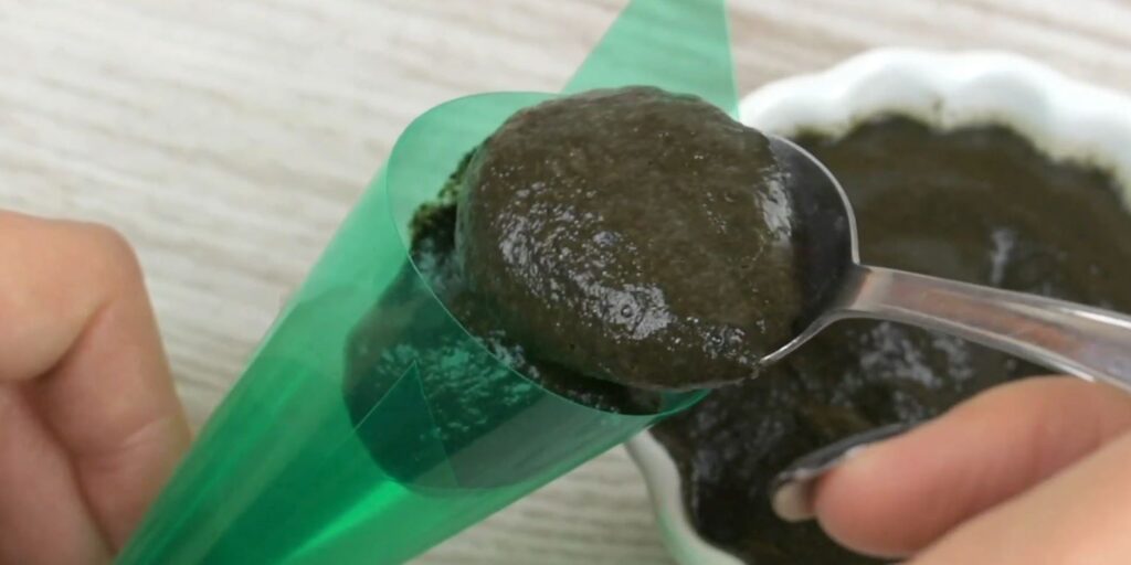 Filling henna paste into homemade mehndi cone